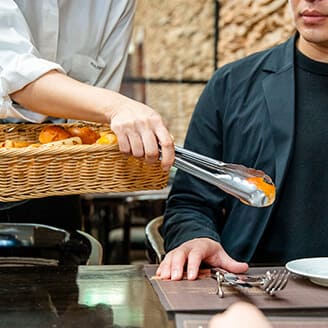 女性ホールスタッフが接客をしている。